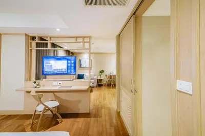 an office with a desk and a computer in a room at Shama Petchburi 47 Bangkok in Bangkok