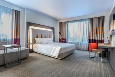 a hotel room with a bed and a desk at Four Points by Sheraton Bangkok Ploenchit Sukhumvit in Bangkok