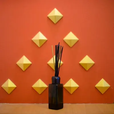 a black vase with yellow paper origami at Golden House in Bangkok