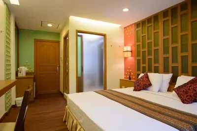 a hotel room with a bed and a bathroom at Golden House in Bangkok