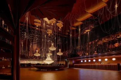 a room with many chandeliers hanging from the ceiling at Asia Hotel Bangkok in Bangkok