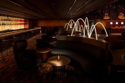 a bar with a row of tables and chairs at Asia Hotel Bangkok in Bangkok