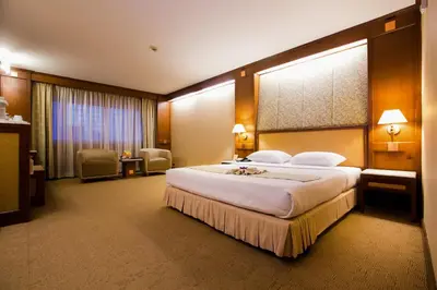 a bedroom with a large bed in a hotel room at Asia Hotel Bangkok in Bangkok