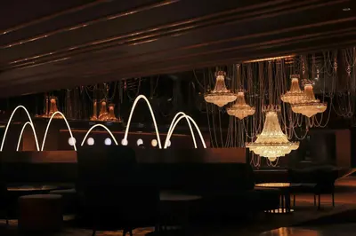 a dining room with chandeliers and tables and chairs at Asia Hotel Bangkok in Bangkok