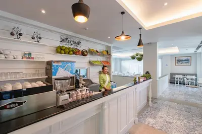 a woman standing at the counter of a restaurant at Siam Tharadol in Bangkok