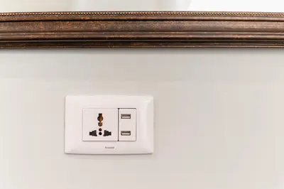 a picture of a light switch on a wall at Siam Tharadol in Bangkok
