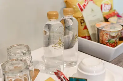 two bottles of water are sitting on a table at Siam Tharadol in Bangkok