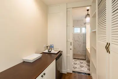 a bathroom with a sink and a shower at Siam Tharadol in Bangkok