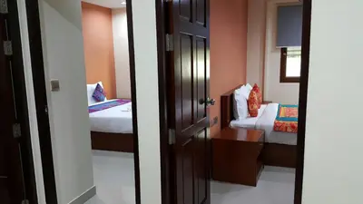 a room with two beds and an open door at The Supara in Bangkok