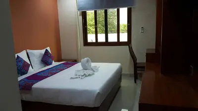 a bedroom with a bed and a window and a bed sidx sidx sidx at The Supara in Bangkok