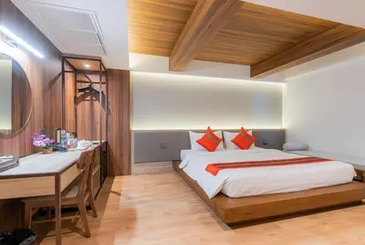 a bedroom with a bed and a desk in it at True Siam Phayathai Hotel in Bangkok