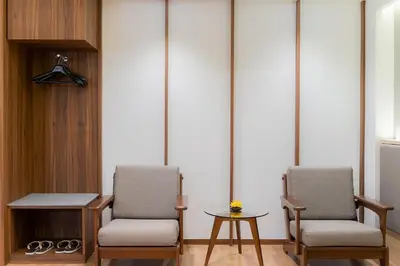 two chairs and a table in a room at True Siam Phayathai Hotel in Bangkok