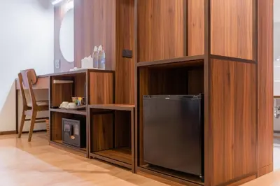 a room with a tv in a wooden wall at True Siam Phayathai Hotel in Bangkok