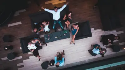an overhead view of a group of people sitting around a pool at ZAZZ Urban Bangkok in Bangkok