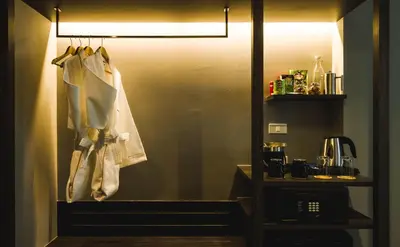 a room with a kitchen with a sink and a lamp at ZAZZ Urban Bangkok in Bangkok