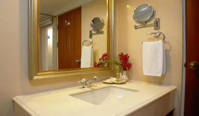 a bathroom with a sink and a mirror and towels at NASA BANGKOK - Airport Rail Link Ramkhamhang in Bangkok