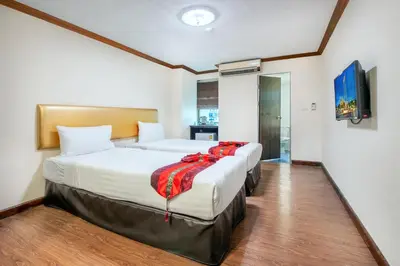 a hotel room with two beds and a flat screen tv at NASA BANGKOK - Airport Rail Link Ramkhamhang in Bangkok