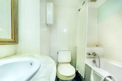 a bathroom with a toilet and a tub and a sink at NASA BANGKOK - Airport Rail Link Ramkhamhang in Bangkok