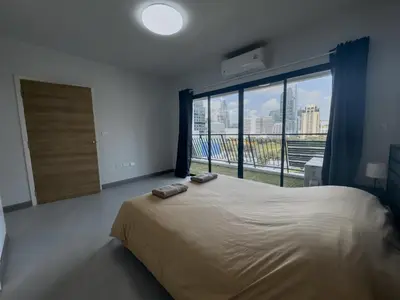 a bedroom with a large bed and a large window at Nice view over the heart of Bangkok in Bangkok