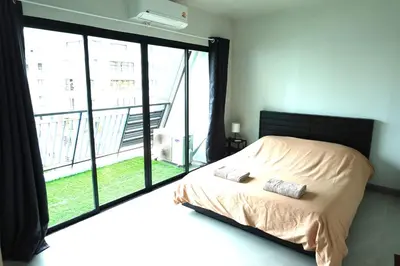 a bedroom with a bed and a large window at Nice view over the heart of Bangkok in Bangkok