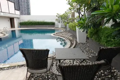 a patio with chairs and a swimming pool at Nice view over the heart of Bangkok in Bangkok