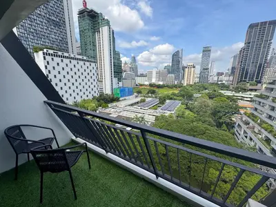 a balcony with a chair and a view of a city at Nice view over the heart of Bangkok in Bangkok