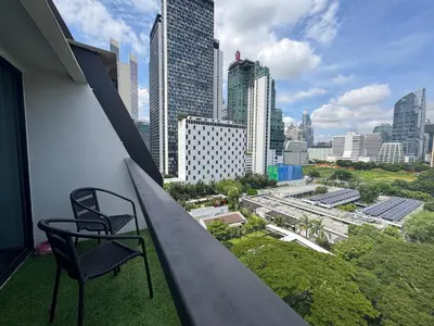 a chair on a balcony with a view of a city at Nice view over the heart of Bangkok in Bangkok