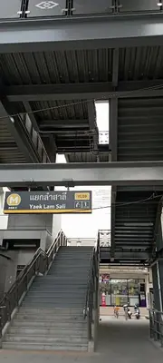 a stairway in a building with stairs and a sign at SKB Mansion close to MRT in Hua mark in Bangkok