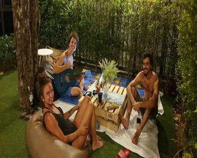 a group of three people sitting on a couch at Wayha Hostel Don Mueang Airport in Bangkok