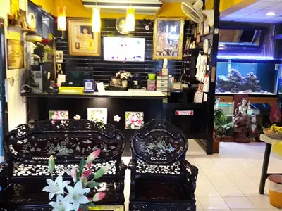 two chairs sitting in a room with a store at Thaiphiphat house in Bangkok