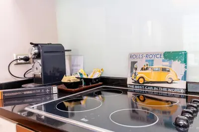a kitchen with a sink and a stove top oven at Sky Villas Apartments in Bangkok