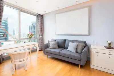 a living room with a couch and a desk at Sky Villas Apartments in Bangkok