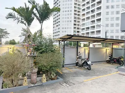 a parking lot with two motorcycles parked under a pavilion at Goody Hotel in Bangkok