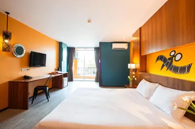 a hotel room with a bed and a desk at MeStyle Place Hotel in Bangkok