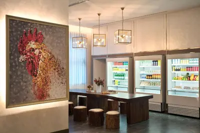 a bar in a restaurant with a painting of a rooster at Hyatt Place Bangkok Sukhumvit 24 in Bangkok