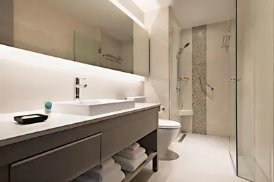 a bathroom with a sink and a toilet and a shower at Hyatt Place Bangkok Sukhumvit 24 in Bangkok