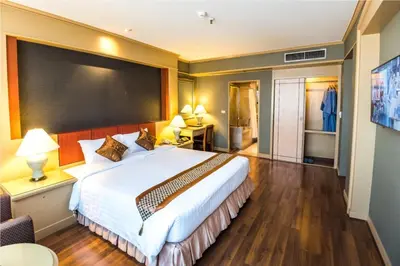 a bedroom with a large white bed in a room at The Maruay Garden Hotel in Bangkok