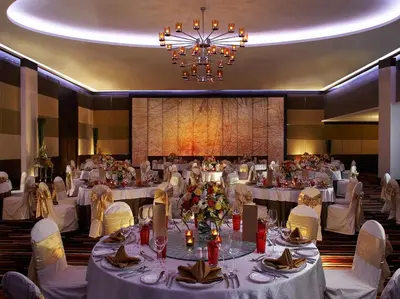 a large banquet hall with white tables and chairs at The Landmark Bangkok in Bangkok