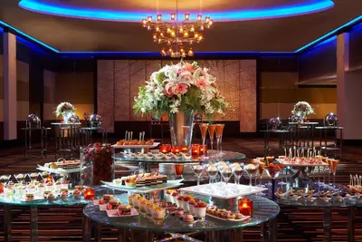 a table of food in a room with a bunch of desserts at The Landmark Bangkok in Bangkok