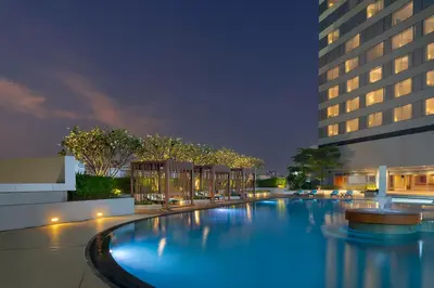 a large swimming pool in front of a building at Jubilee Prestige Hotel Ratchadapisek in Bangkok