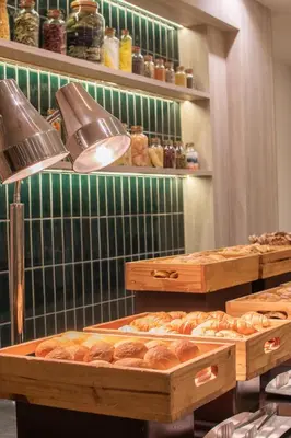 a bakery with many different types of bread at Twin Towers Hotel in Bangkok