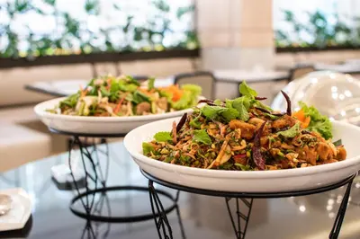 two bowls of food sitting on a table at Twin Towers Hotel in Bangkok