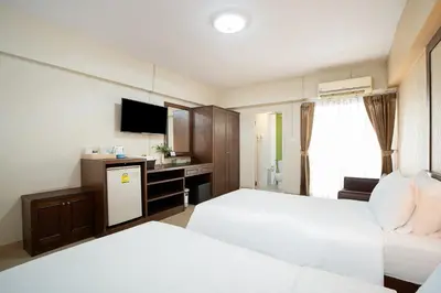 a hotel room with two beds and a television at P-Park Suvarnabhumi in Bangkok