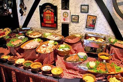 a table topped with lots of food on a table at Stable Lodge - SHA Certified in Bangkok