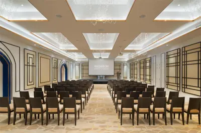 a conference room with chairs and a projection screen at Radisson Hotel Chateau de Bangkok in Bangkok