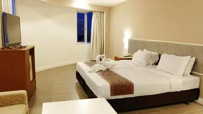a hotel room with a bed and a television at Trang Hotel Bangkok - SHA Plus in Bangkok