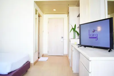 a living room with a flat screen tv on a counter at Trang Hotel Bangkok - SHA Plus in Bangkok