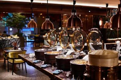 a buffet line of food in a restaurant at Valia Hotel Bangkok in Bangkok