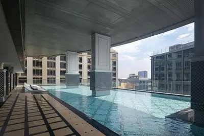 a large swimming pool on top of a building at Valia Hotel Bangkok in Bangkok