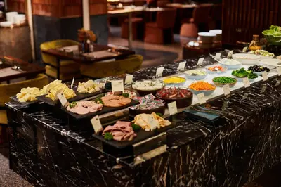 a buffet with many different types of food on a table at Valia Hotel Bangkok in Bangkok